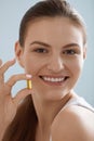 Vitamin. Smiling woman with omega 3 pill, fish oil capsule Royalty Free Stock Photo