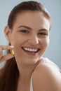 Vitamin. Smiling woman with omega 3 pill, fish oil capsule Royalty Free Stock Photo