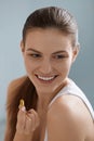 Vitamin. Smiling woman with omega 3 pill, fish oil capsule Royalty Free Stock Photo