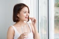 Vitamin And Supplement. Closeup Of Beautiful Young Woman Taking Yellow Fish Oil Pill