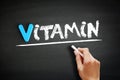 Vitamin text on blackboard, health concept background