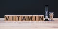 Vitamin word from cubes on background.
