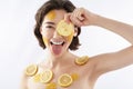 Funny smiling woman with many lemon pieces