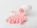 Vitamins. Antiviral drug tablets. Antidepressant. Round pink healthy pills and pill bottle on white background Royalty Free Stock Photo