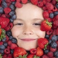 Vitamins from berrie. Child face with berry frame, close up. Berries mix blueberry, raspberry, strawberry, blackberry Royalty Free Stock Photo