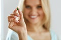 Vitamins And Food Supplements. Beautiful Woman With Pill In Hand Royalty Free Stock Photo