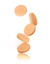 Vitamins pills falling down closeup on white Royalty Free Stock Photo
