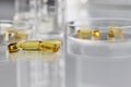 Vitamins pills omega 3 supplements with petri dish Royalty Free Stock Photo