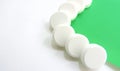 Vitamins pills on a white-green background Royalty Free Stock Photo