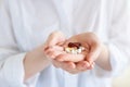 Vitamins And Supplements. Closeup of hand holding variety of white pills on palm. Close-up Of Medication Tablets, Capsules From Royalty Free Stock Photo