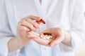 Vitamins And Supplements. Closeup of hand holding variety of white pills on palm. Close-up Of Medication Tablets, Capsules From Royalty Free Stock Photo