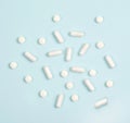 Vitamins in white tablets on a blue background Royalty Free Stock Photo