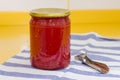 Vitamins on yellow table, tomato paste in glass jar and can opener on striped towel Royalty Free Stock Photo