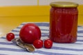 Vitamins on yellow table, tomato, cherry and tomato paste in glass jar and can opener on striped towel Royalty Free Stock Photo