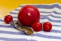 Vitamins on yellow table, tomatos and can opener on striped towel Royalty Free Stock Photo