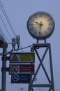 Luminous clock with Roman numerals and information signs Royalty Free Stock Photo