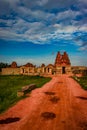Vithala temple with leading red soil road and amazing blue sky at hampi ruins Royalty Free Stock Photo