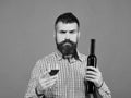 Viticulture and autumn concept. Man with beard holds glass of red wine Royalty Free Stock Photo