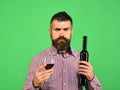 Viticulture and autumn concept. Man with beard holds glass of red wine Royalty Free Stock Photo