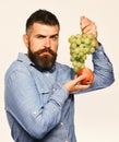 Viticulture and gardening concept. Farmer shows his harvest. Winegrower with serious face Royalty Free Stock Photo