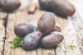 Vitolette noir or purple potato. On a wooden table.