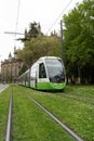 Electric tram circulating on tracks covered with grass through the city of Vitoria, Pais Vasco,