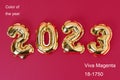 Viva magenta color of the year 2023. New Year 2023. Foil balloons numbers 2023 on red background. New Year Christmas.