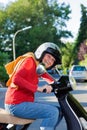 Vivacious elderly woman riding a scooter