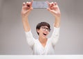 Vivacious woman laughing as she takes a selfie Royalty Free Stock Photo