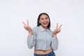 A vivacious young asian woman makes a double peace sign. Feeling upbeat and elated. Isolated on a white background