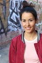 Vivacious young woman with shoulder length brunette hair in a bun and a beautiful smile laughing happily Royalty Free Stock Photo