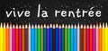 Vive la rentree meaning Back to school written on black chalkboard with colorful wooden pencils