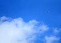 Vivid blue sky with flying jet plane and white clouds for the concept of travel or journey Royalty Free Stock Photo