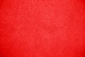 Vivid bright red color coarse facade wall as an empty rustic texture background