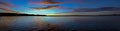 Vivid colored coastal sunrise cloudscape panorama. Royalty Free Stock Photo