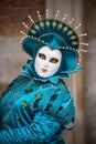 Vivid colorful blue mask and costume of a queen in the Venice carnival