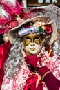 Vivid colorful red and white costume in the Venice carnival