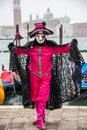 Vivid colorful pink and black costume in the Venice carnival