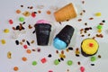 Vivid colors Ice cream in chocolade black cones with peanuts, waffle cup strewed with dried fruits and caramel sweets scattered on