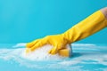 In this vivid composition, a hand in a yellow rubber glove vigorously scrubs a surface with a soapy sponge, symbolizing Royalty Free Stock Photo