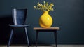 Vivid Contrasts: Lush Lemon Tree in a Sunny Yellow Pot with a Blue Stool Against a Dark Wall. Royalty Free Stock Photo