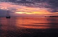 Vivid crimson clouds and sky sunrise seascape with water reflect