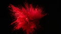 Vivid crimson red pigment powder exploding dramatically against a deep black background capturing the intense energy of a dynamic Royalty Free Stock Photo