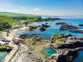 Vivid emerald-green water at Ballintoy harbour along the Causeway Coast in County Antrim