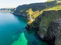 Vivid emerald-green water at Ballintoy harbour along the Causeway Coast in County Antrim