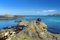 Vivid emerald-green water at Ballintoy harbour along the Causeway Coast in County Antrim. Rugged coast of Northern Ireland