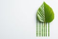 A vivid green leaf is seamlessly transitioning into a barcode pattern against a soft white backdrop. Bright midday light Royalty Free Stock Photo