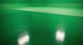Vivid Green Screen Studio Background with Reflective Floor for Chroma Key Visual Effects Royalty Free Stock Photo