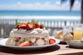 A vivid image of a berry-topped Pavlova against a sunny Australian Christmas beach scene. Royalty Free Stock Photo