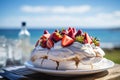 A vivid image of a berry-topped Pavlova against a sunny Australian Christmas beach scene. Royalty Free Stock Photo